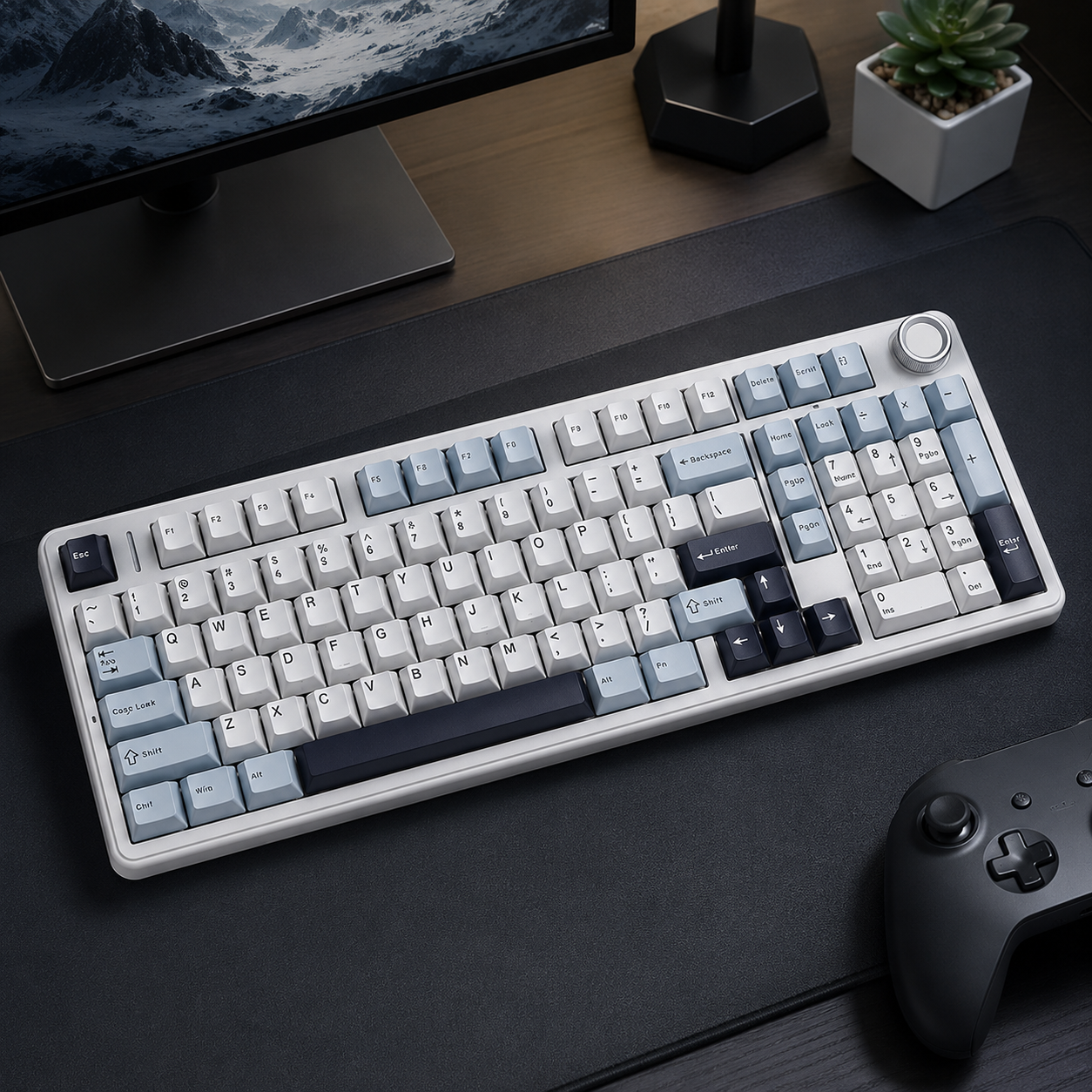 retro style keyboard with dial sits on a black desk with a game control off to the side, classic gray blue and navy colors
