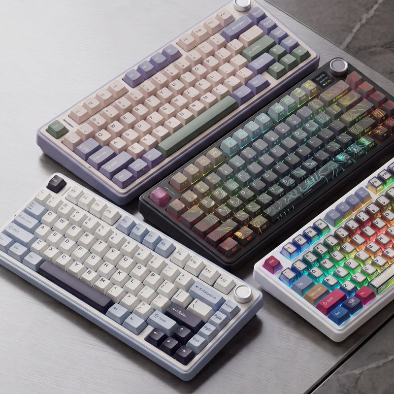 Four different mechanical keyboards on a gray surface
