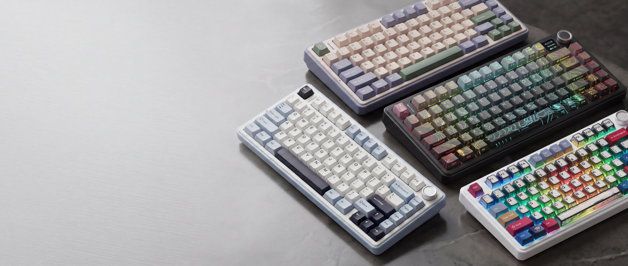 Four colorful mechanical keyboards on a gray surface